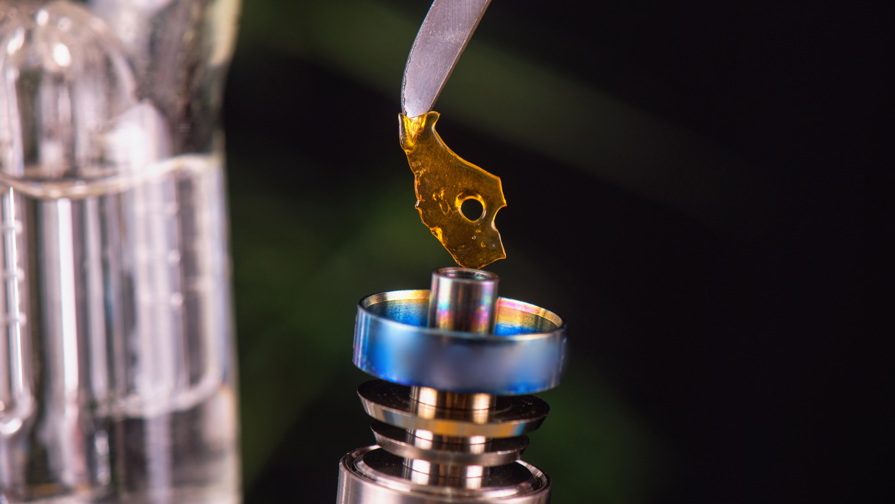 A dabbing tool with piece of potent cannabis concentrate shatter