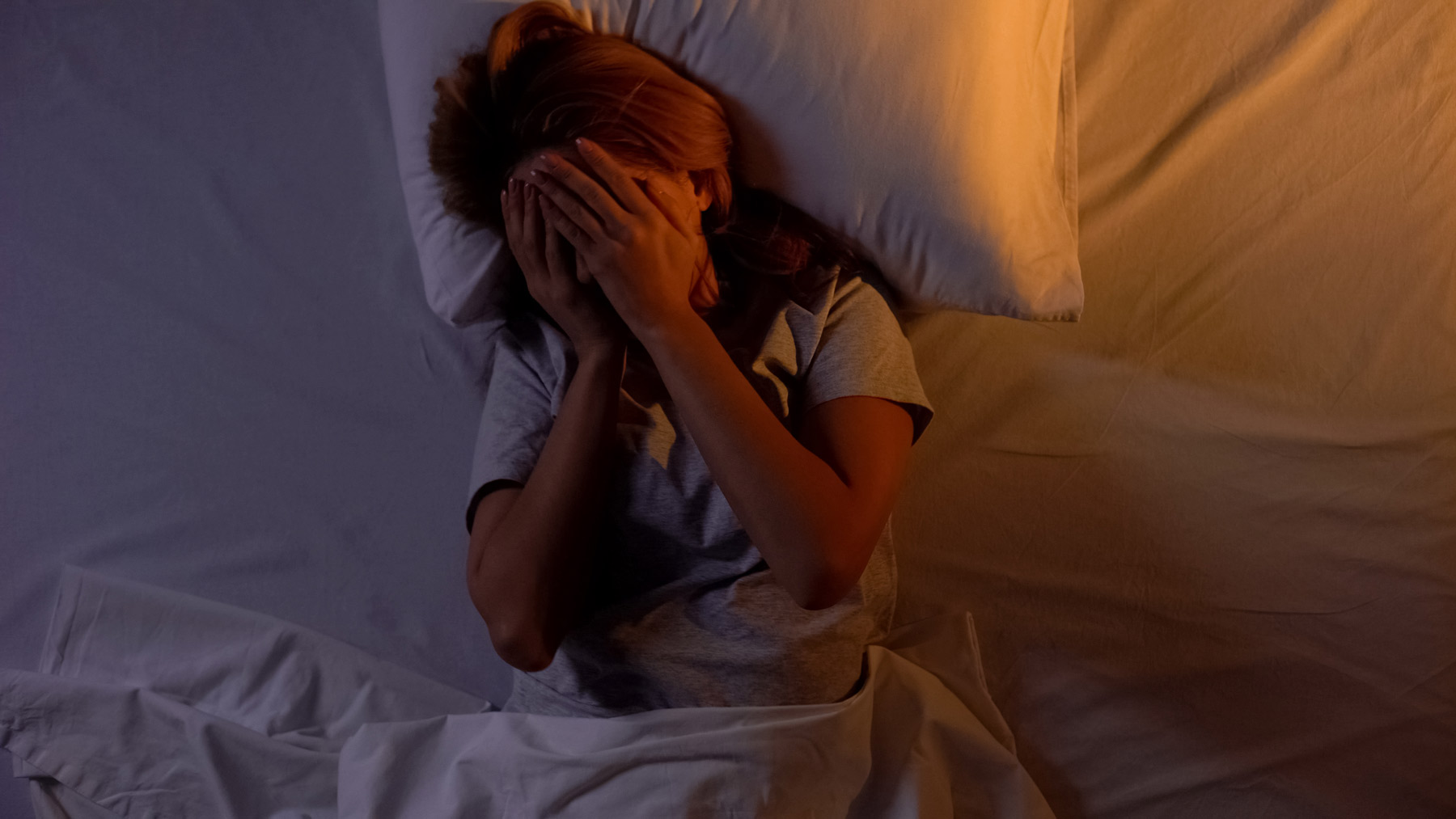 Women in bed having withdrawal symptoms from an Ambien addiction